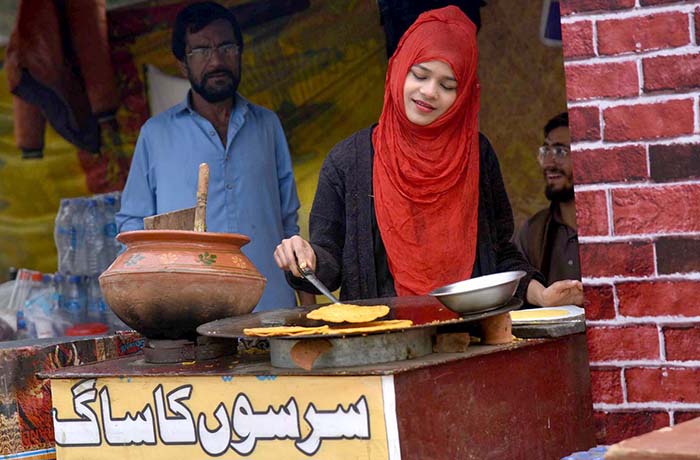 A woman is working hard to earn livelihood in the city while International Women's Day is celebrating over the globe.