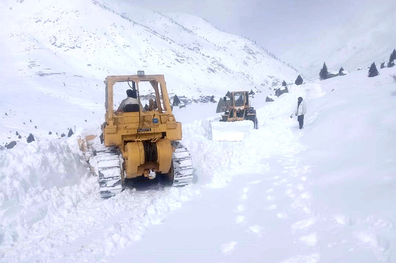 Heavy machinery being used to remove snow and boulders from the blocked road of Astore Valley by the staffer of Gilgit-Baltistan Disaster Management authority and Works Department after heavy sonw fall and rain in area caused land sliding in diffident area