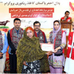 Additional Director Pakistan Red Crescent Society Ms. Asima Naseem distributing handover buffaloes certificates to flood-affected families of deserving households with the collaboration of the IFRC during a ceremony at Municipal Stadium, organized by Pakistan Red Crescent Society