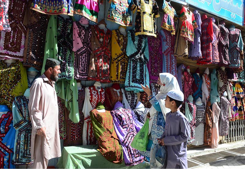 Woman looking for traditional Balochi dresses for Eid-ul-Fitr at Liaqat Bazar