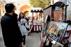 A woman looks to the displayed painting and calligraphy during an exhibition in collaboration with The Fortnite School System at Food Street, Fort Road.