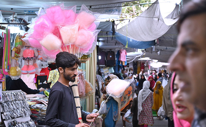 A street hawker selling cotton candy at G-9 Markaz