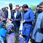 Prime Minister Muhammad Shehbaz Sharif consoling the affectees of torrential rains at a relief camp