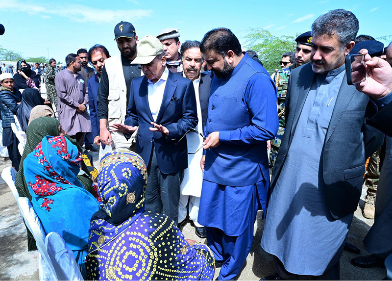 Prime Minister Muhammad Shehbaz Sharif consoling the affectees of torrential rains at a relief camp