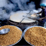 A worker busy in frying traditional food item Pakoriyaa mostly used in Dahi Bhalle during Iftar in the holy fasting month of Ramzan