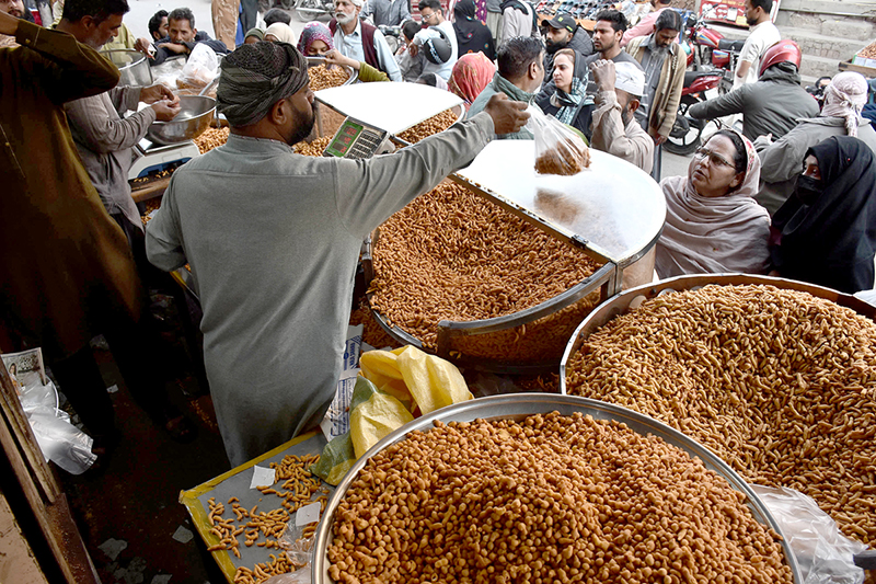 People purchasing the traditional fritter Pakoriyaa mostly used in Dahi Bhalle during the holy fasting month of Ramzan.