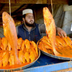 Vendor displaying fishes for customers at Joint Road