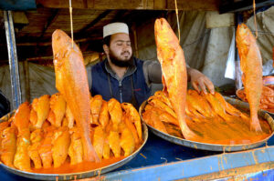 Vendor displaying fishes for customers at Joint Road