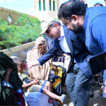 Prime Minister Muhammad Shehbaz Sharif consoling the affectees of torrential rains at a relief camp