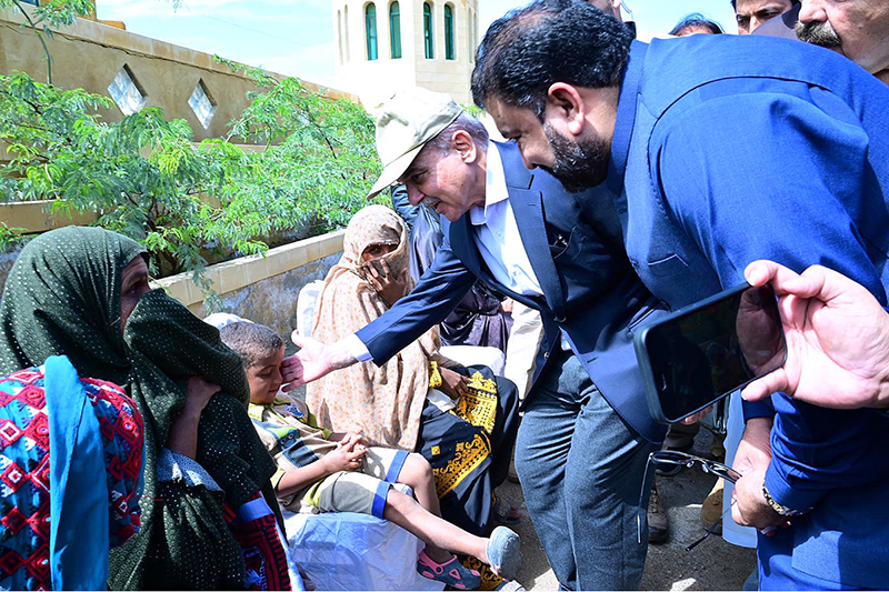 Prime Minister Muhammad Shehbaz Sharif consoling the affectees of torrential rains at a relief camp