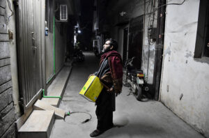 A drum beater walks around the residential area, beating his Tin drum to wake people up for Sehri at Allama Iqbal Town in Holy fasting month of Ramzan.