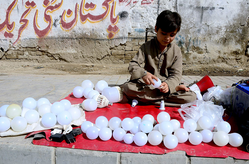 A teenager boy repairing LED bulbs at Joint Road to earn for livelihood