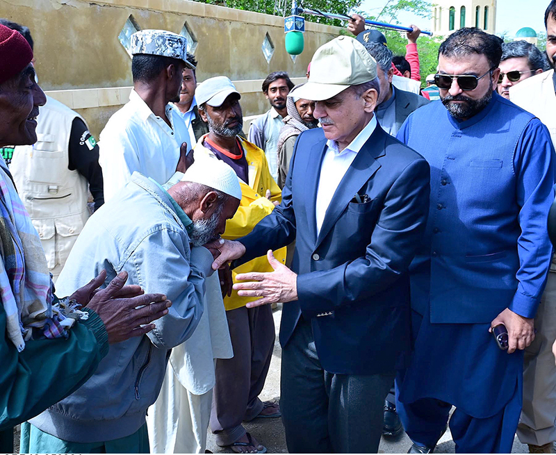 Prime Minister Muhammad Shehbaz Sharif consoling the affectees of torrential rains at a relief camp