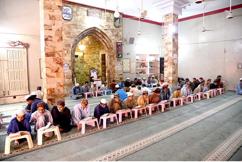 Madrasa students reciting Holy Quran in a mosque during Holy Fasting Month of Ramzan