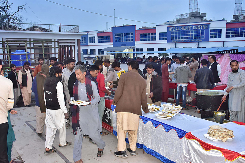 Volunteers distributing Iftar to the fasting people at Govt Allam Iqbal Teaching Hospital.