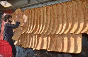 Vendor displaying Afghani Naans to attract customer at his shop near Meezan Chowk.