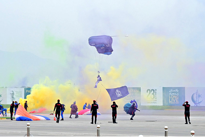 Pakistan Army paratroopers showing their skills, participate in Pakistan Day 2024 parade ceremony, at Shakarparian Parade Ground