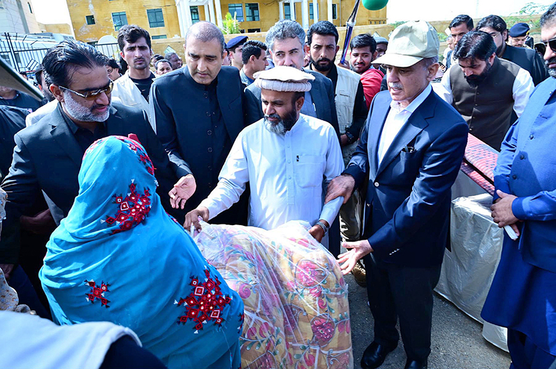 Prime Minister Muhammad Shehbaz Sharif distributes relief items among the affectees of torrential rains