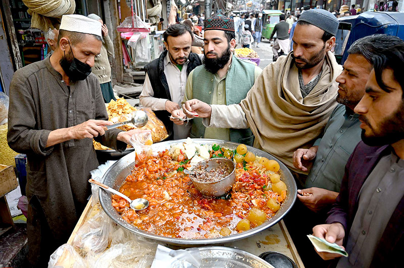 A vendor selling traditional sweet item Murabba to attract the customers during Ramadan