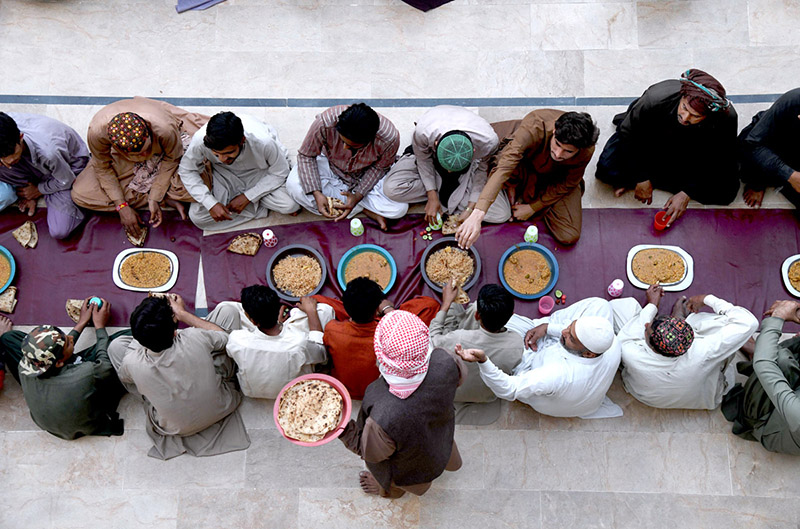 A large number of people breaking fast (Iftar) in the holy month of Ramzan ul Mubarak at a local Masjid