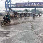 Vehicles passing through stagnant rain water accumulated on road in the Provincial Capital