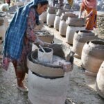 Women workers busy in preparing traditional oven (Tandoor) at their workplace outskirts in the Provincial Capital