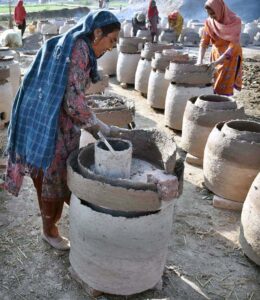 Women workers busy in preparing traditional oven (Tandoor) at their workplace outskirts in the Provincial Capital