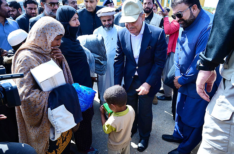 Prime Minister Muhammad Shehbaz Sharif distributes relief items among the affectees of torrential rains
