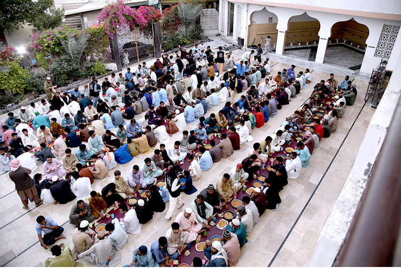 A large number of people breaking fast (Iftar) in the holy month of Ramzan ul Mubarak at a local Masjid