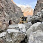 Heavy machinery being used to remove stone from the blocked road of Astore Valley by the staffer of Gilgit-Baltistan Disaster Management authority and Works Department after heavy snow fall and rain in area caused land sliding in diffident area.