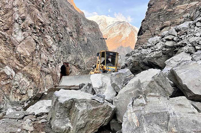 Heavy machinery being used to remove stone from the blocked road of Astore Valley by the staffer of Gilgit-Baltistan Disaster Management authority and Works Department after heavy snow fall and rain in area caused land sliding in diffident area.