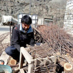 A skilled person making traditional wooden basket for fishing purpose