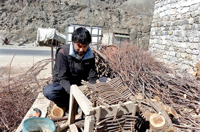 A skilled person making traditional wooden basket for fishing purpose