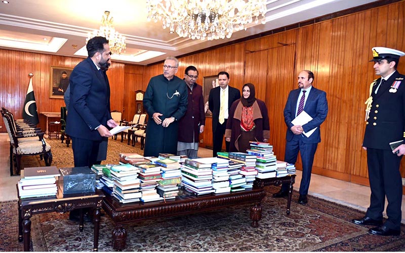President Dr Arif Alvi gifting books to the National Library of Pakistan, at Aiwan-e-Sadr