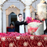 BiBi Aseefa Bhutto Zardari showering flowers on the grave of Shaheed Zulfaqar Ali Bhutoo at Garhi Khuda Bakhsh