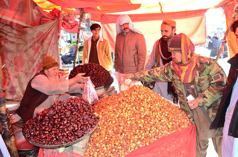 People purchasing Dates from a vendor at Meezan Chowk