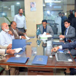 Hon'ble Dr. Khalid Maqbool Siddiqui Federal Minister for Education and Professional Training is being briefed by the NAVTTC Regional office officials during his visit