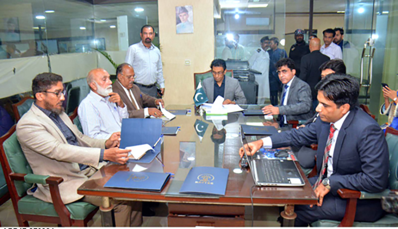 Hon'ble Dr. Khalid Maqbool Siddiqui Federal Minister for Education and Professional Training is being briefed by the NAVTTC Regional office officials during his visit