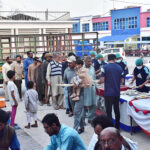 Volunteers distributing food for Iftar among fasting people at Allama Iqbal memorial teaching hospital