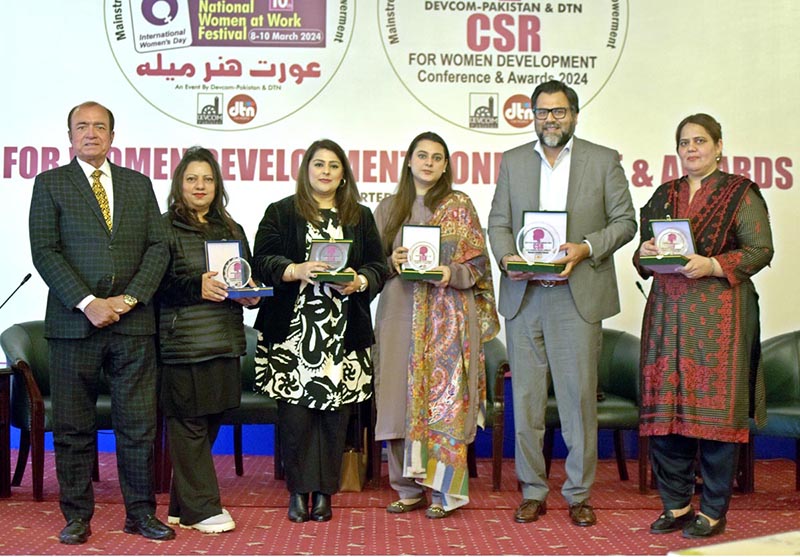 A group photo of the awards winners and panelists of the CSR for Women Development Conference