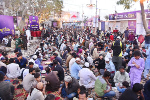 Volunteers distributing food among fasting people during an Iftar at Numaish Chowrangi