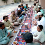 People offering Duaa before breaking their fast during the first Iftar of Ramadan at a local mosque