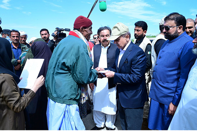 Prime Minister Muhammad Shehbaz Sharif distributes relief items among the affectees of torrential rains