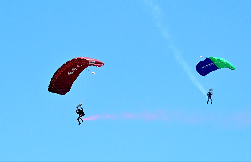 Pakistan Army paratroopers demonstrate their skills during free dive participating in Pakistan Day 2024 parade ceremony, at Shakarparian Parade Ground