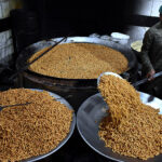 A worker busy in frying traditional food Pakoriyaa mostly used in Dahi Bhalle during the holy fasting month of Ramzan