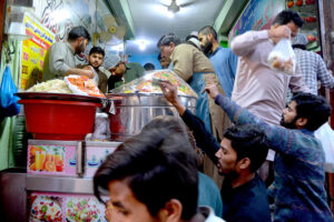 People offering Duaa before breaking their fast during the first Iftar of Ramadan at a local mosque