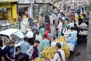 People buying fruits from a vendor on 2nd day of Ramazan at Saddar