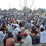 People breaking their fast at a roadside in Old Subzi Mandi
