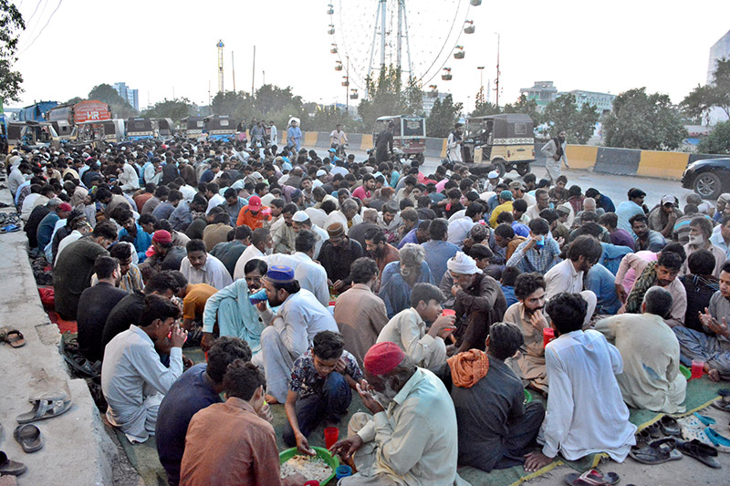 People breaking their fast at a roadside in Old Subzi Mandi