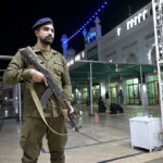 A security personnel high alert during first Tarawih people praying in congregation in Gol Chowk Masjid